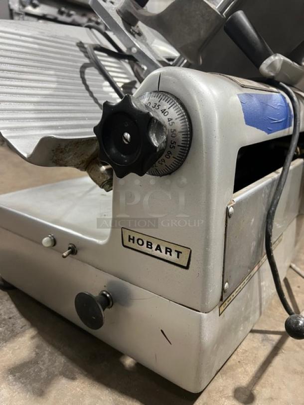 Hobart 1712 commercial deli meat slicer, heavy-duty, electric, countertop model, 115V, visible brand label, good condition.