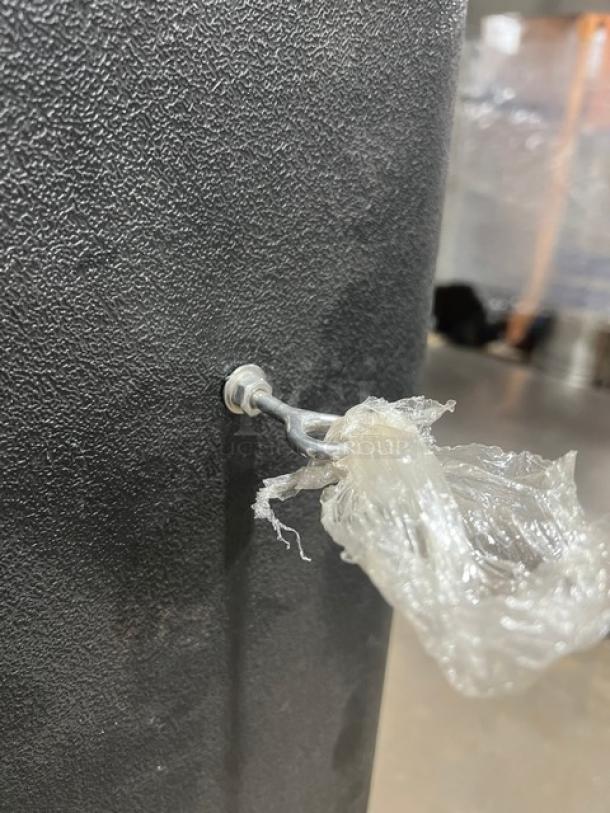 Ice-O-Matic Elevation Series ICE1006HA2 ice machine head, new condition, textured black exterior, showing hook with plastic wrap.