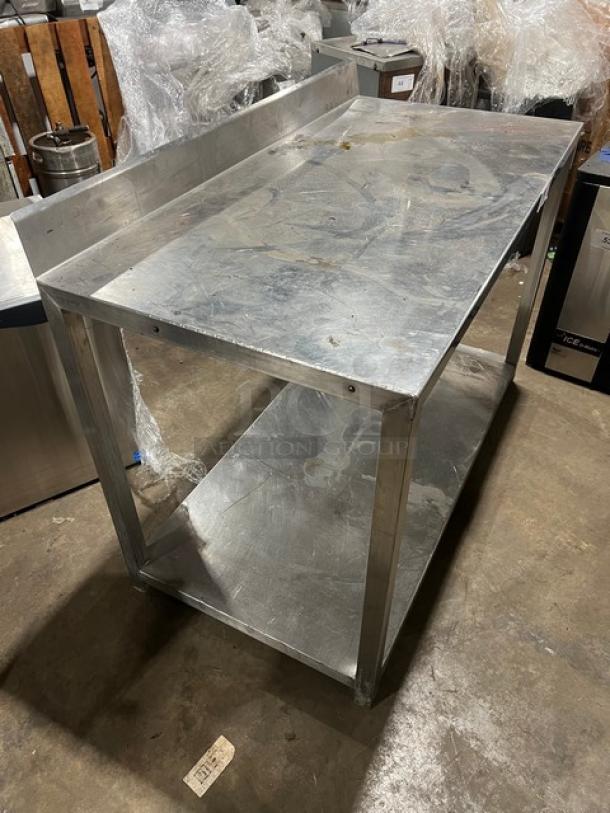 Commercial stainless steel food prep work table, features single undershelf, good condition, durable for kitchen use.