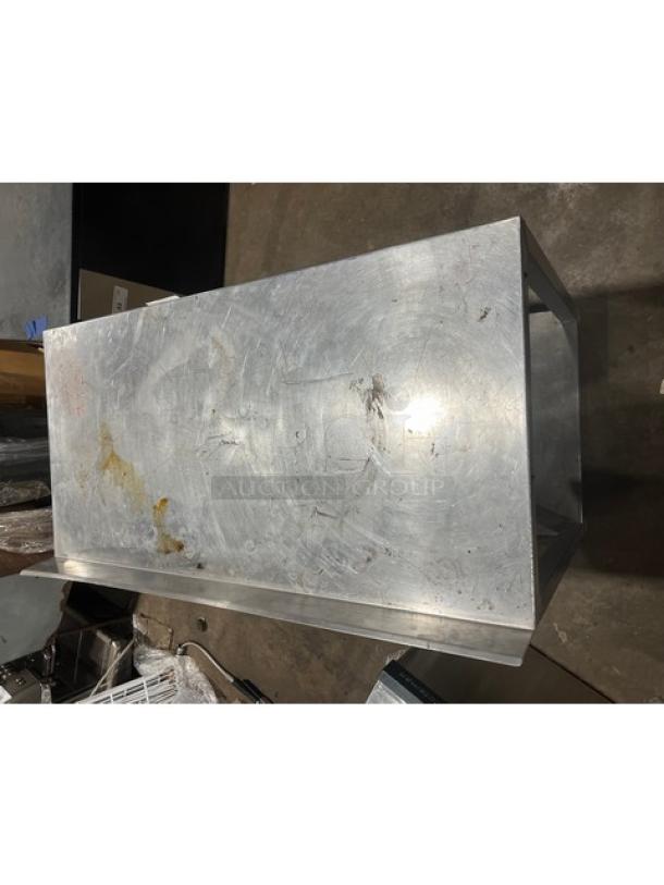 Commercial stainless steel food prep work table with one undershelf. Features visible wear and scratches.