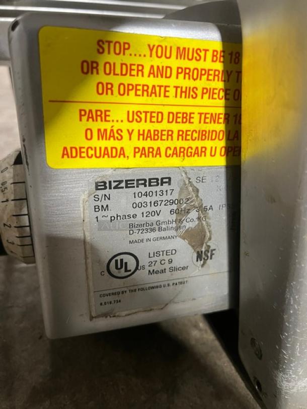 Bizerba stainless steel countertop deli meat slicer, electric powered, 120V, 1 phase, S/N: 10401317, visible warning labels.