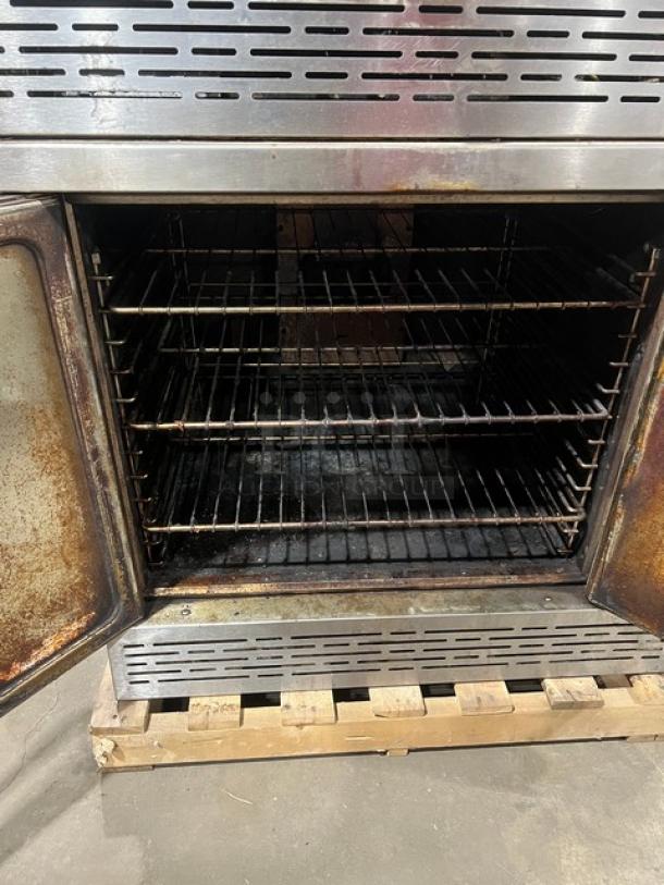 Imperial commercial stainless steel double-stacked convection oven with wired rack, on casters, natural gas powered, used.