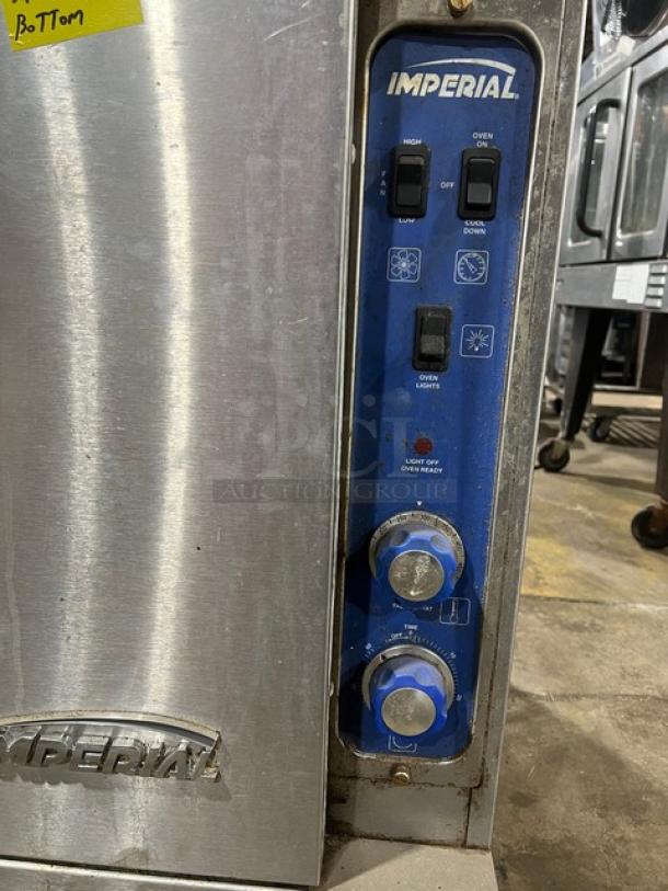 Imperial stainless steel double-stacked convection oven, natural gas-powered, wired rack, control panel visible, on casters.