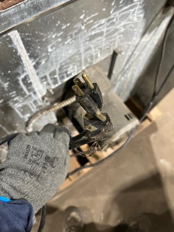 Industrial plug for Imperial commercial convection oven, showing three prongs. Appears used, attached to wired unit.