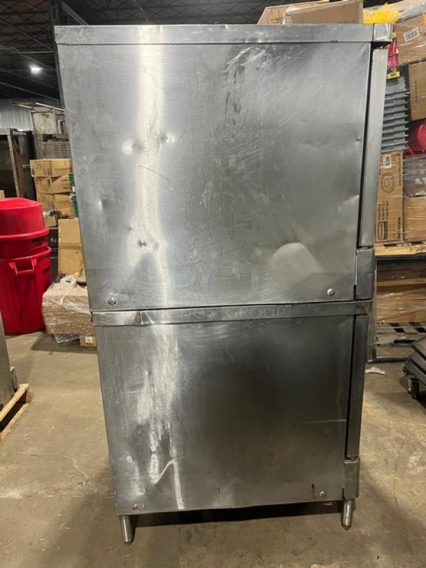 Blodgett stainless steel double stacked convection oven, natural gas, on legs. Includes wired oven rack. Visible wear.