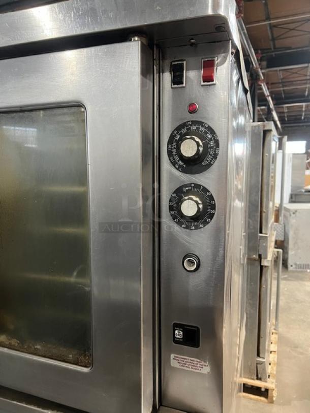 Blodgett commercial stainless steel double stacked convection oven, natural gas, with wired rack, on legs. Control dials visible.