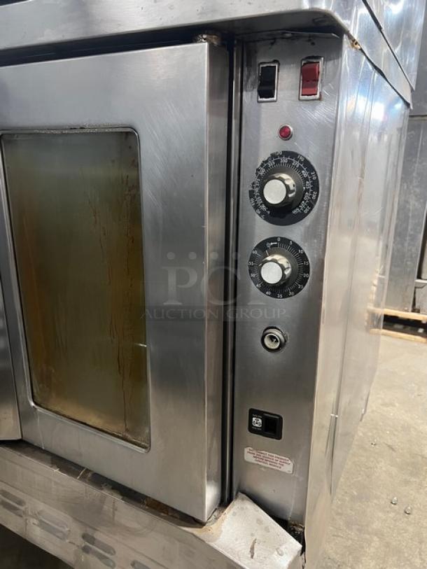 Blodgett commercial stainless steel double-stacked convection oven, natural gas, with wired rack, on legs. Controllers visible.