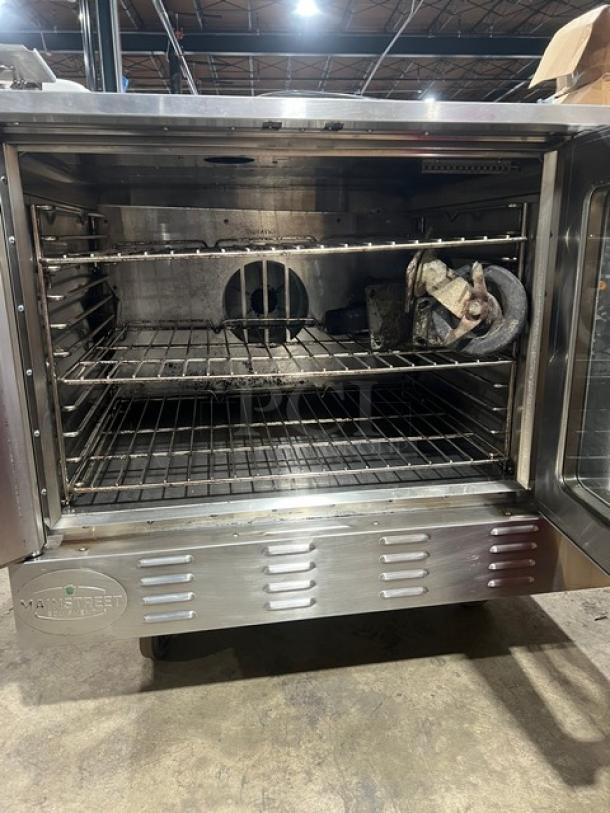 Mainstreet Equipment commercial stainless steel convection oven, model FGC100, with wired rack, on casters.