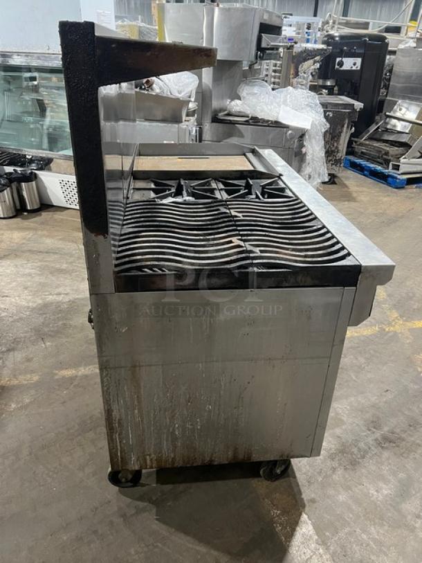 Southbend commercial stainless steel range with griddle, double oven combo, back and side splash, and overhead salamander shelf on casters.