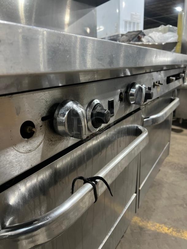 Southbend commercial stainless steel range/griddle/oven combo with knobs, back and side splash, on casters, good condition.