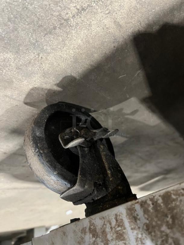 Close-up of a caster wheel on a Southbend commercial kitchen appliance, showing its condition and metal frame.