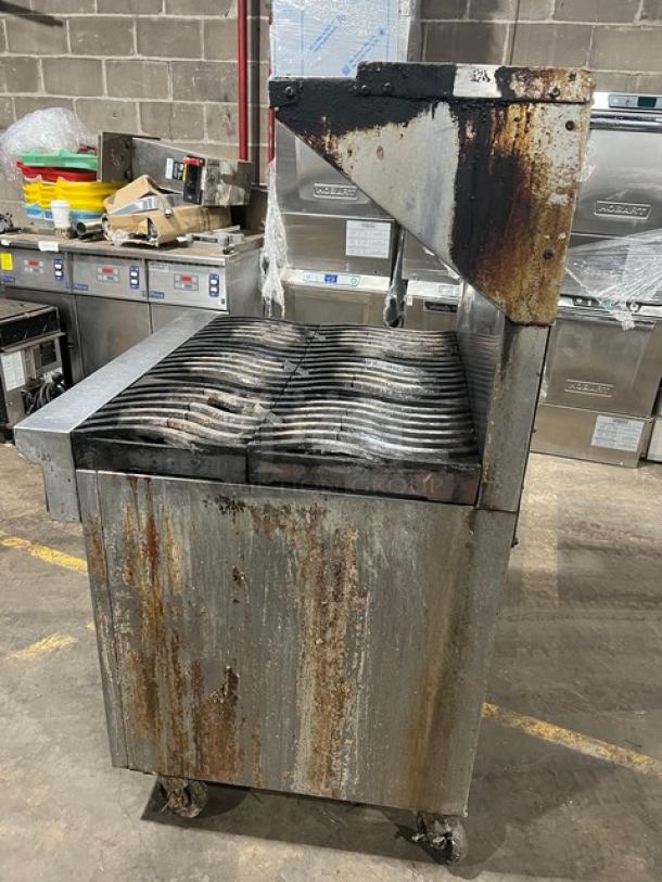 Southbend commercial 6-burner range/oven combo, stainless steel, with backsplash, overhead salamander shelf, on casters, showing signs of wear.