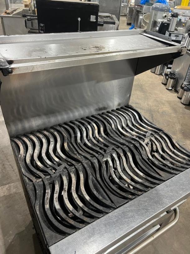 Southbend commercial stainless steel 6-burner range/oven combo with backsplash, overhead salamander shelf, and casters.