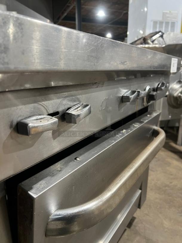 Southbend commercial stainless steel 6-burner range/oven combo with backsplash, overhead salamander shelf, and wired oven rack.