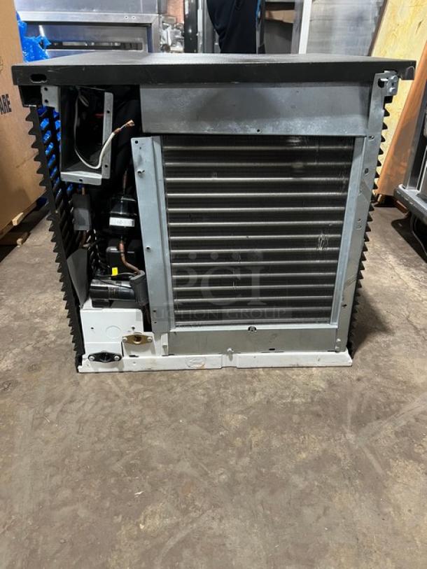 Commercial stainless steel electric ice making machine head in good condition, featuring visible internal components.