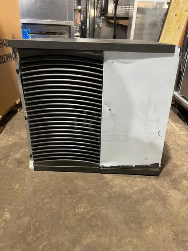 Commercial stainless steel ice making machine head, electric powered, featuring a vented front panel. Some visible surface wear.