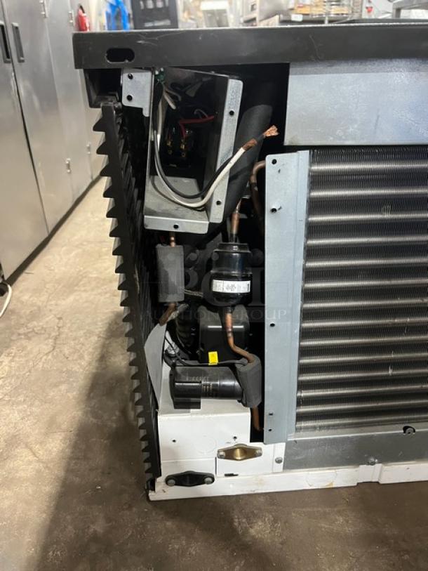 Commercial stainless steel electric ice making machine head, showing internal components. Appears in good condition.