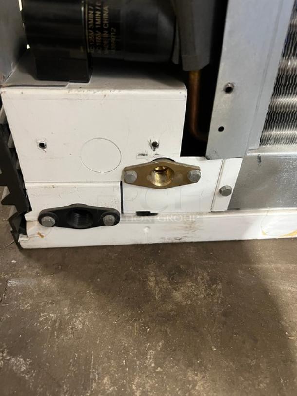 Commercial stainless steel electric ice maker head, showing mechanical components, in good condition.