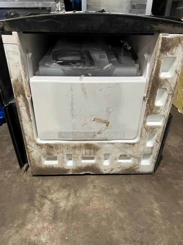 Stainless steel electric ice making machine head in used condition, visible wear on surface, includes components inside.