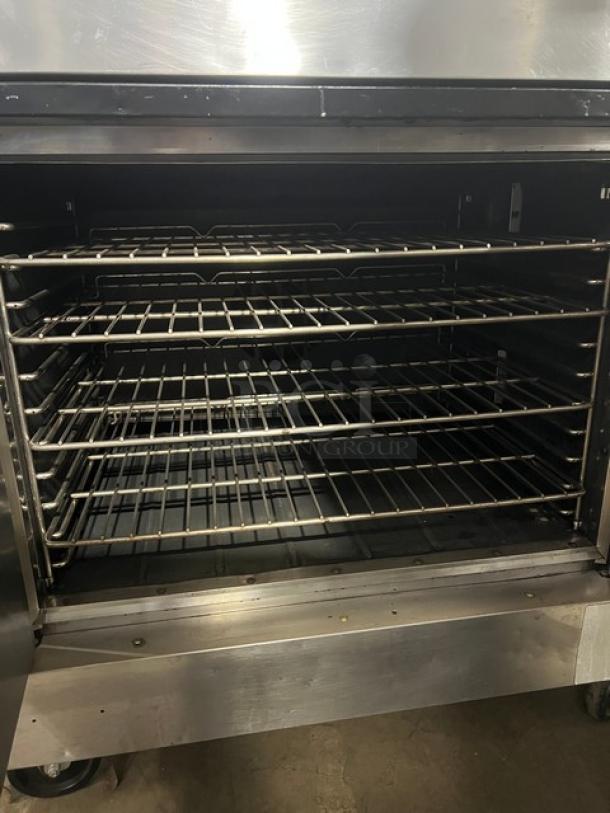 Southbend SilverStar Series double-stacked gas convection oven with wired oven rack on casters. Stainless steel, commercial-grade.