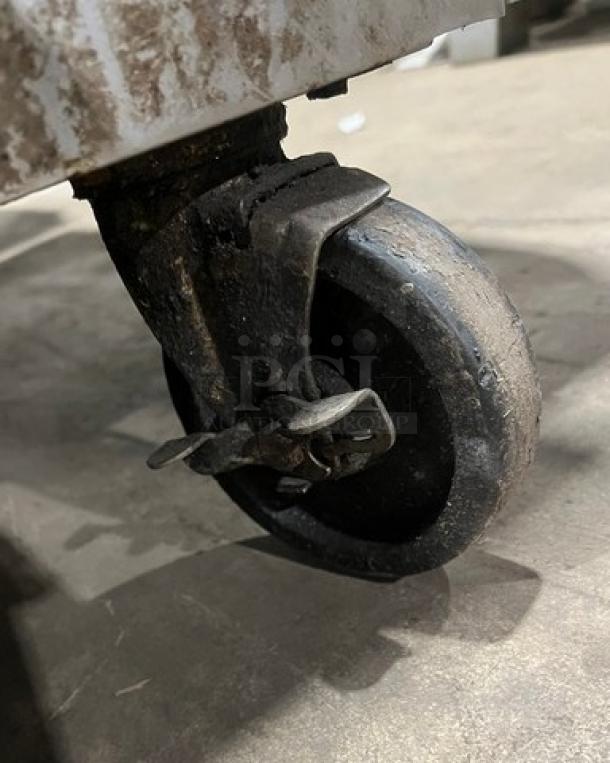 Close-up of a caster wheel on a Southbend commercial kitchen appliance, showing its condition and metal frame.