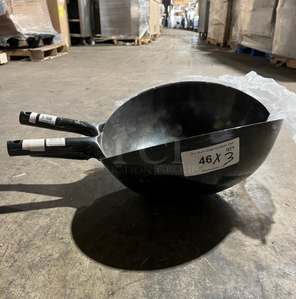 Commercial black non-stick frying pans with ergonomic handles stacked together. Label indicates "46 x 3 qty." Ideal for kitchen use.