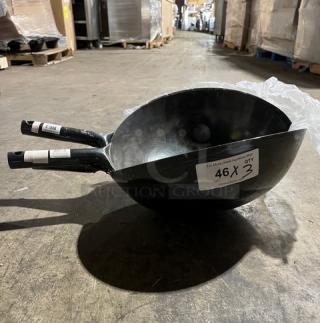 Commercial black non-stick frying pans with ergonomic handles stacked together. Label indicates "46 x 3 qty." Ideal for kitchen use.