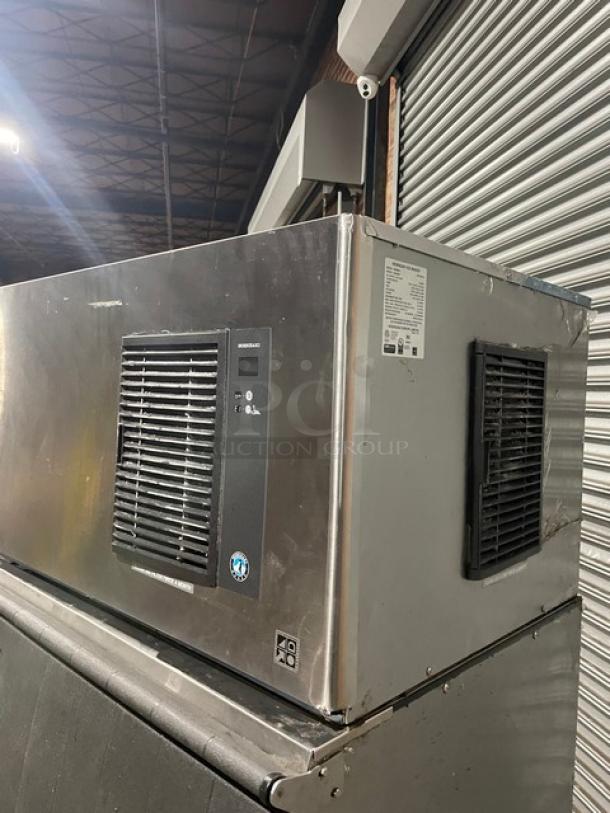 Hoshizaki IM500SAA commercial ice maker with air-cooling, stainless steel finish, on legs, includes ice scoop. Model: IM-500SAA.