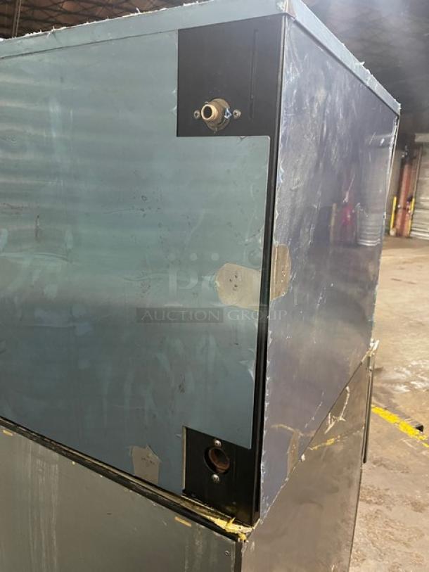 Hoshizaki IM-500SAA stainless steel ice machine, electric-powered, air-cooled, with visible wear, on legs.