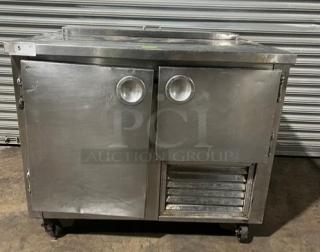 Commercial stainless steel refrigerated salad/sandwich prep table, 1-1/2 door, poly coated rack, on casters, in used condition.
