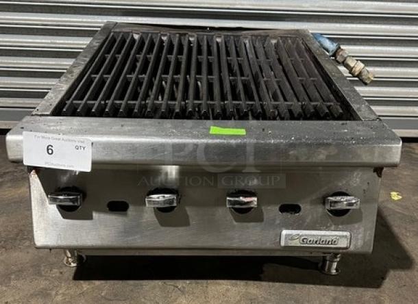 Garland stainless steel gas-powered countertop char broiler with legs; features control knobs and brand label; used condition.