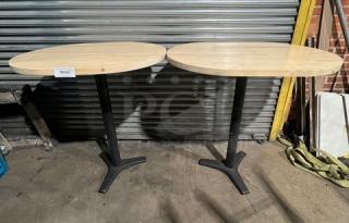 Commercial wooden oval tabletops with pedestal bases, two units shown. Sturdy condition, ideal for dining or business use.