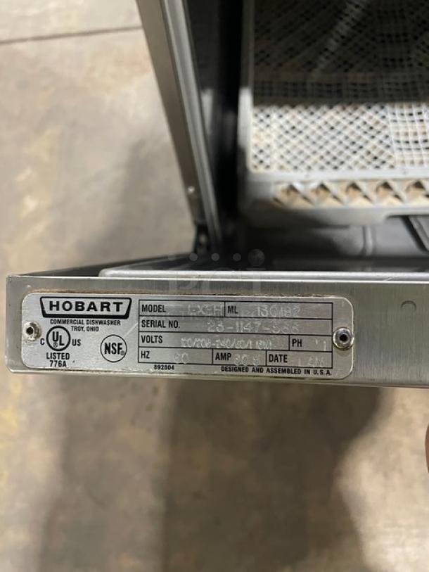 Hobart LXEH commercial dishwasher, stainless steel, includes full-size dish rack, model number and specs visible on label.