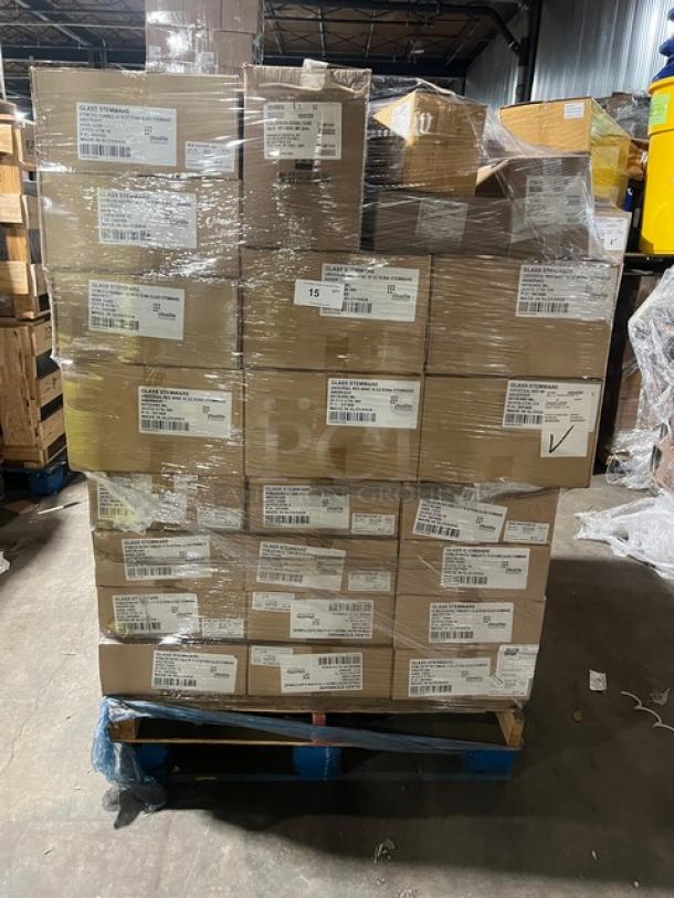 Mixed pallet of Steelite International Rona Series glasses and Tablecraft ice scoop, brand new, boxed, on a warehouse floor.