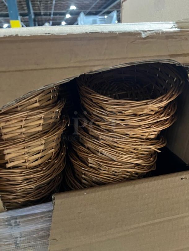 Mixed pallet with natural colored woven wicker baskets stacked in an open cardboard box. Brand new condition.