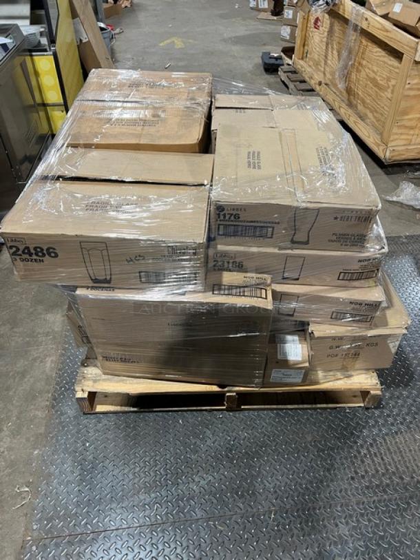 Mixed pallet of Libbey commercial glasses in original boxes, including models 8883, 610, 1176, 23186, 2486, L5635, and 8032BR, wrapped and ready for auction.