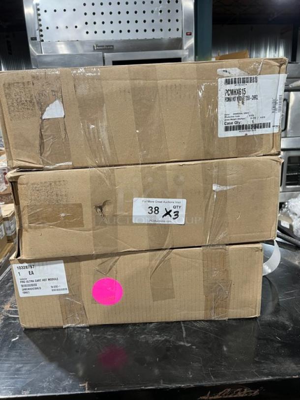 Brand new Cambro Pro Cart Ultra PCMHX615 in boxes, tags showing model, SNs B23-4086/4079/4076, 115V electric, charcoal gray.