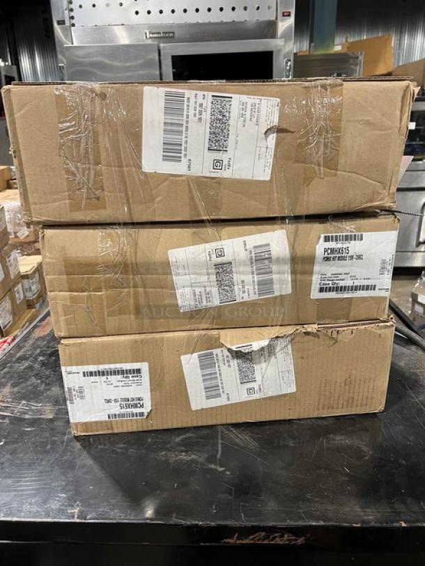 Three boxes containing a new Cambro Pro Cart Ultra, Model PCMHX615, with visible shipping labels and serial numbers.