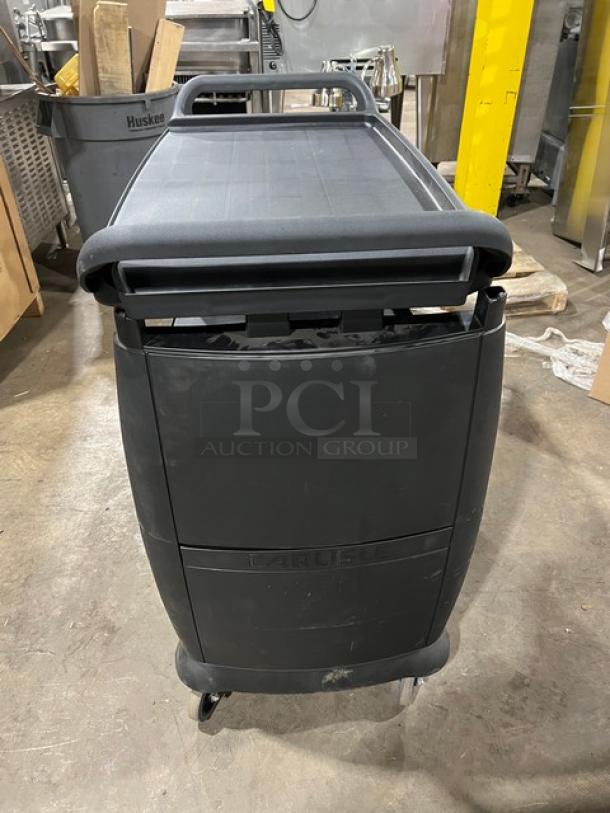 Carlisle black 3-tier utility cart on casters, new with minor scratches. Durable commercial design, ideal for heavy-duty use.