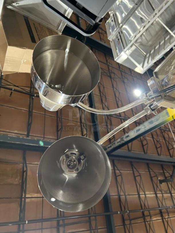 New commercial stainless steel double-head food warming heat lamp with individual power controls, electric powered.