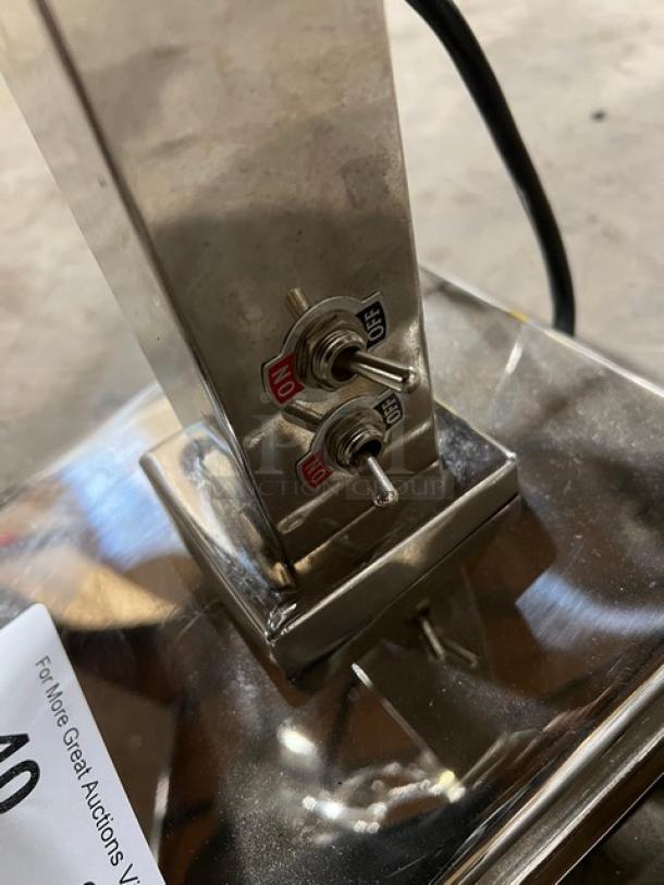 Stainless steel electric double head 2-bulb food warming heat lamp with individual power controls and on/off switches.