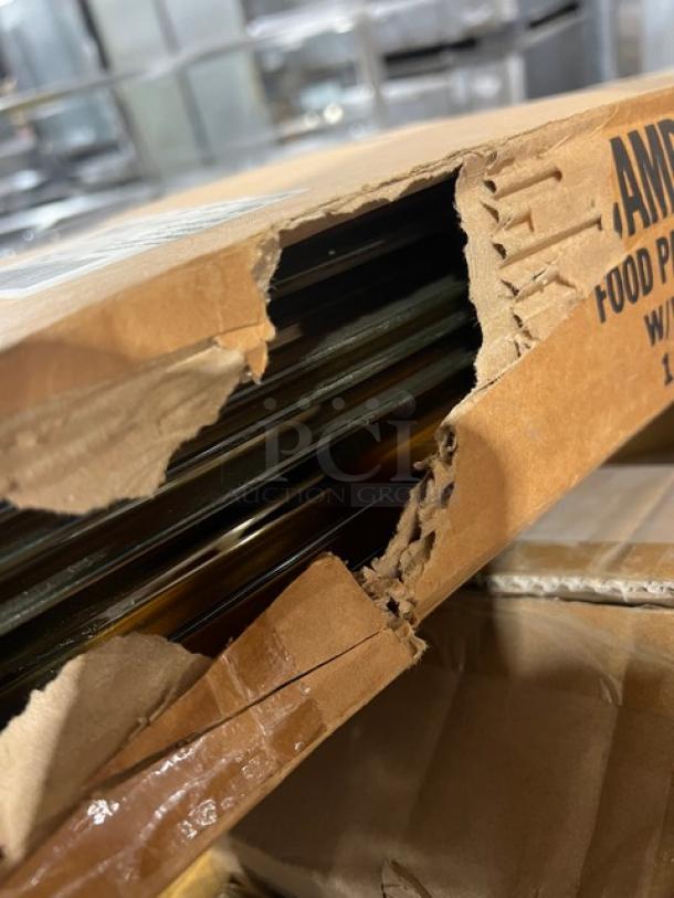 Close-up of a torn box revealing stacked Steelite International plates, showing new, undamaged condition. Box labels indicate contents.