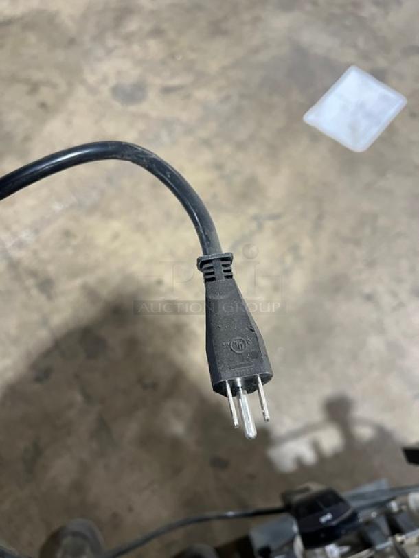 Power cord plug for Vollrath Stoelting CBE127 icee slush dispenser. Black, three-prong, 115V. Suitable for commercial use.