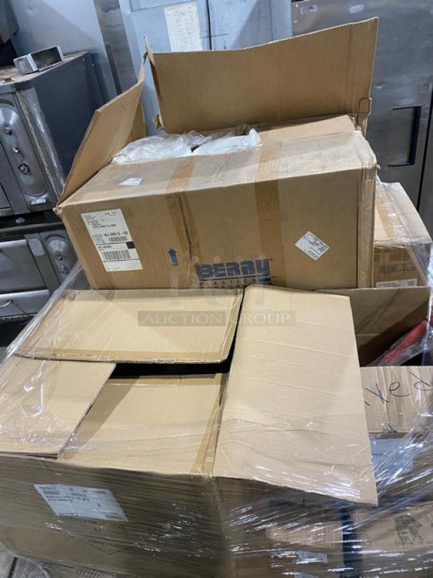 Mixed pallet with multiple boxes containing commercial kitchen items, including Vollrath Traex Series rack, towel packs, spatulas, tasting spoons, and salad forks. Boxes are sealed and labeled with contents.