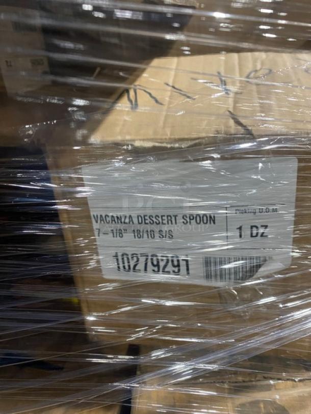 Mixed pallet with Vollrath Traex racks, towel packets, spatulas, bamboo spoons, and Renzo Patina salad forks. Each item in original packaging, visible label "Vacanza Dessert Spoon 7-1/8" 18/10 S/S, 1 DZ, 10279291."