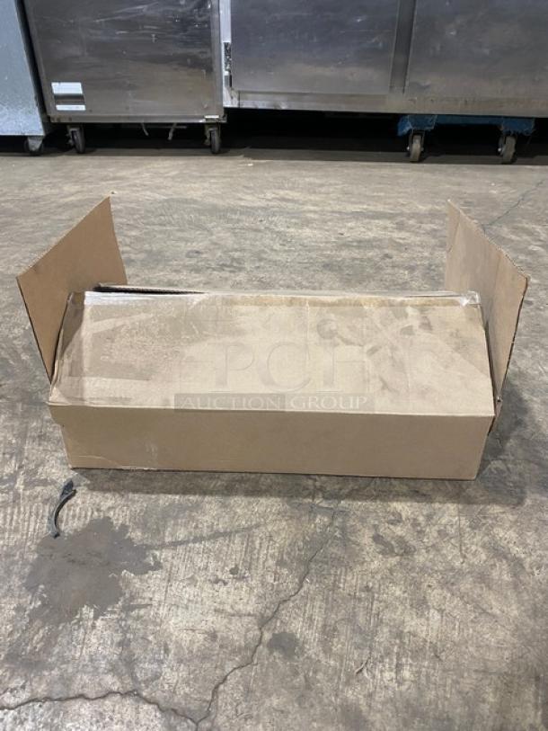 Cardboard box containing a brand new Vollrath 9-3/8" carbon steel fry pan with SteelCoat-x3 coating and black silicone handle.