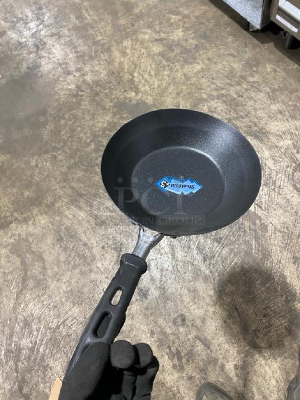 Brand new Vollrath 9-3/8" fry pan, model 5923938, with SteelCoat-x3 non-stick coating and black silicone handle.
