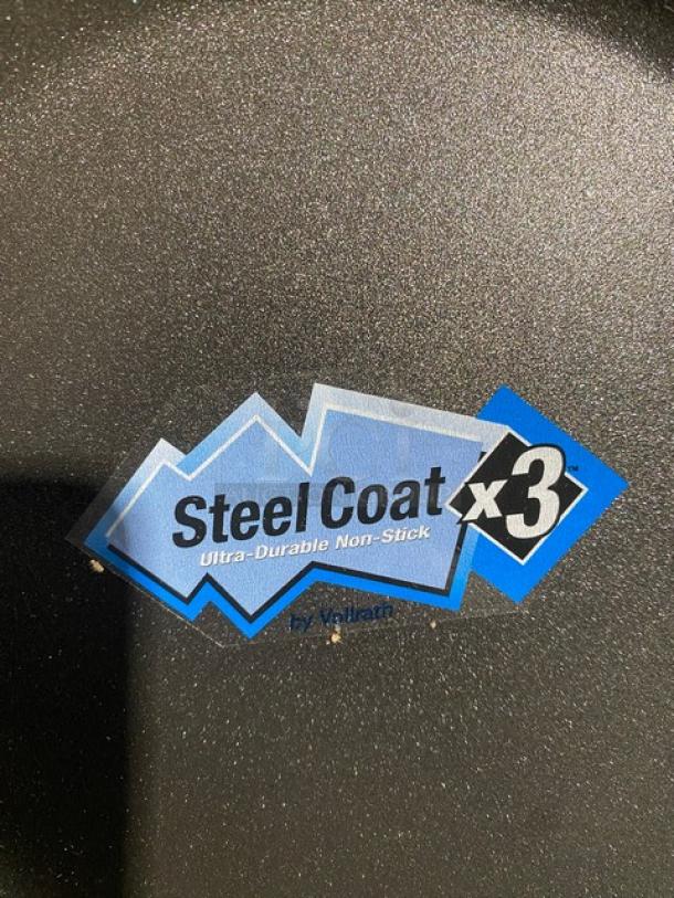 Brand new Vollrath 9-3/8" round fry pan, model 5923938, with SteelCoat-x3 non-stick coating and black silicone grip handle.