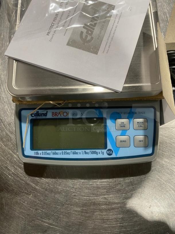 Edlund Bravo BRV-160 digital portion scale with LCD display, stainless steel, ClearShield cover, new condition.
