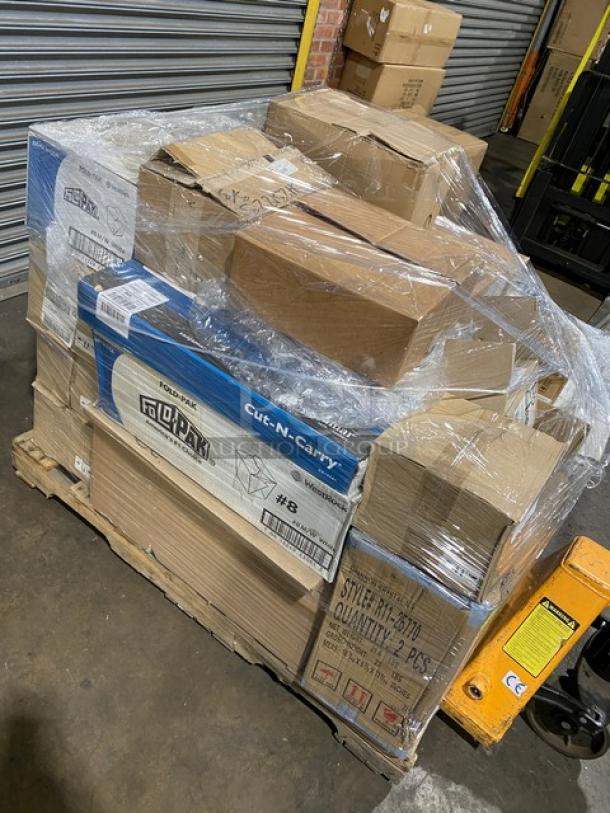 Mixed pallet of brand new commercial kitchen items, including Arcoroc knives, Carlisle tongs, San Jamar cutting boards, and more, wrapped in plastic.